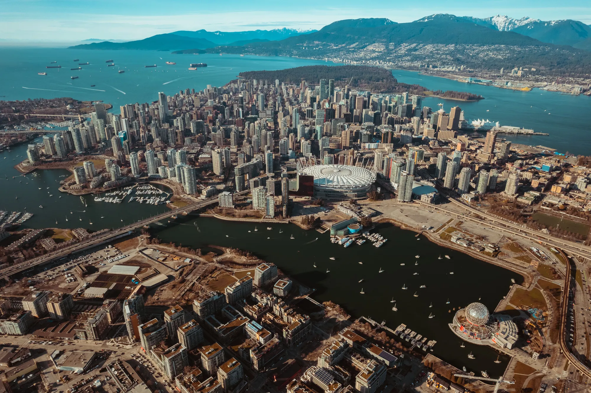Vancouver from the air: downtown, False Creek and Science World, with the North Shore mountains behind